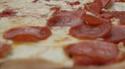 Caruso's pizza pie, half pepperoni half plain